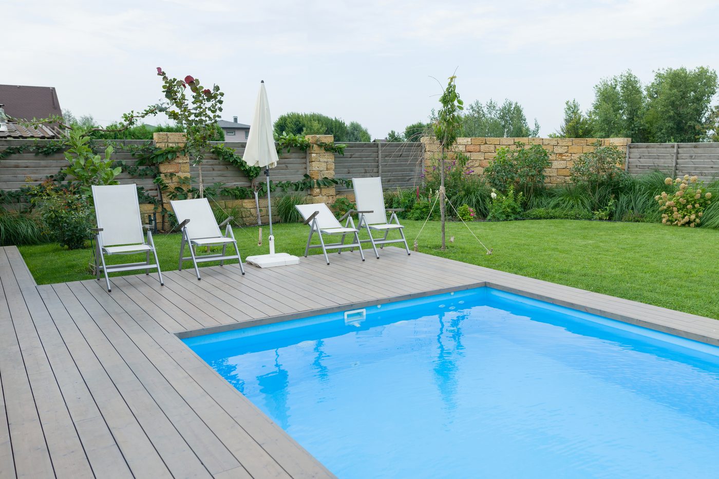A finished inground pool in a Long Island backyard